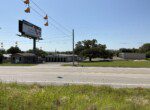 Roadside scene with billboard and storage units.