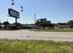 Roadside view with billboard and buildings.